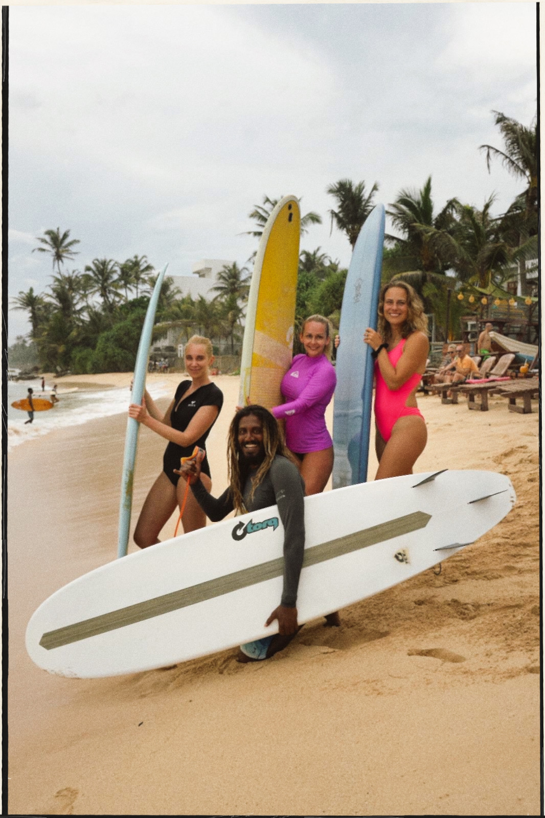 Surf crew with boards on the beach